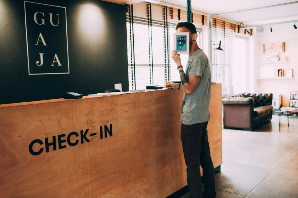 Image of a man checking into a hotel using a credit card.