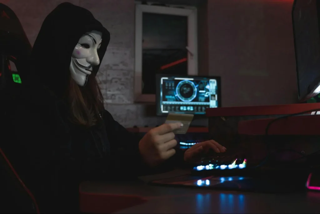 Image of a cyber criminal committing fraudulent acts online.