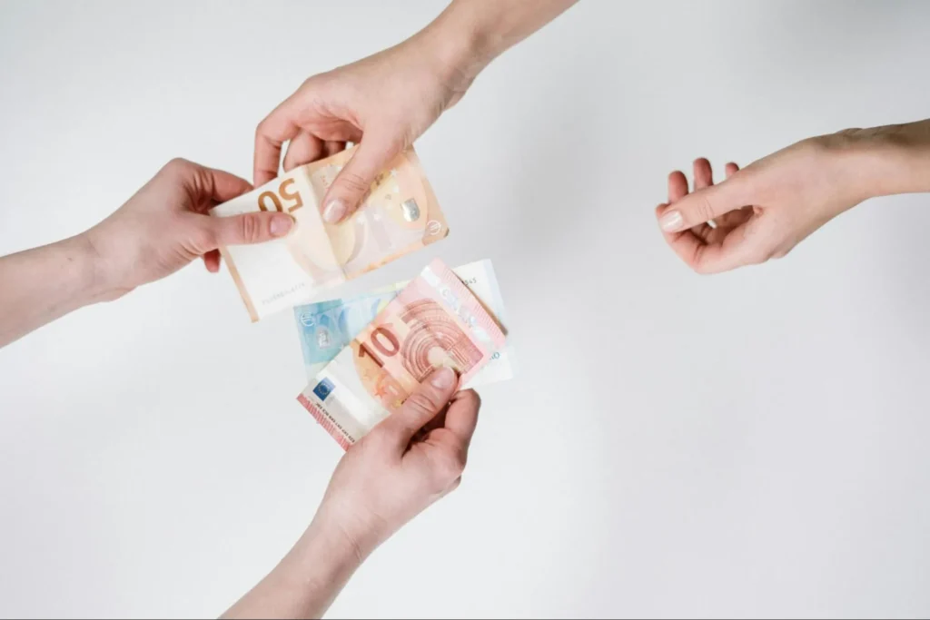 Image of money exchanged, akin to an ACH payment.