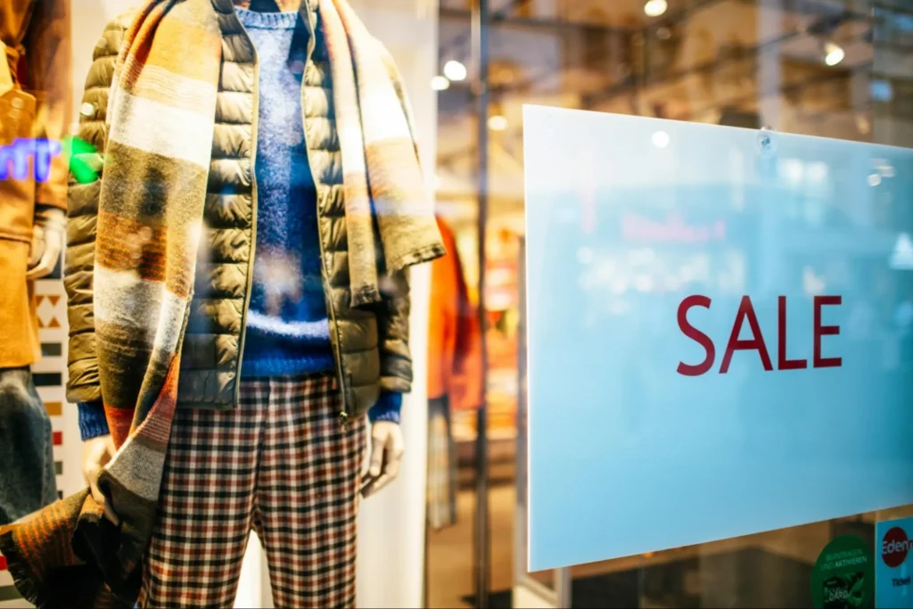 A store window with a sale sign, potentially offering buy now pay later arrangements.
