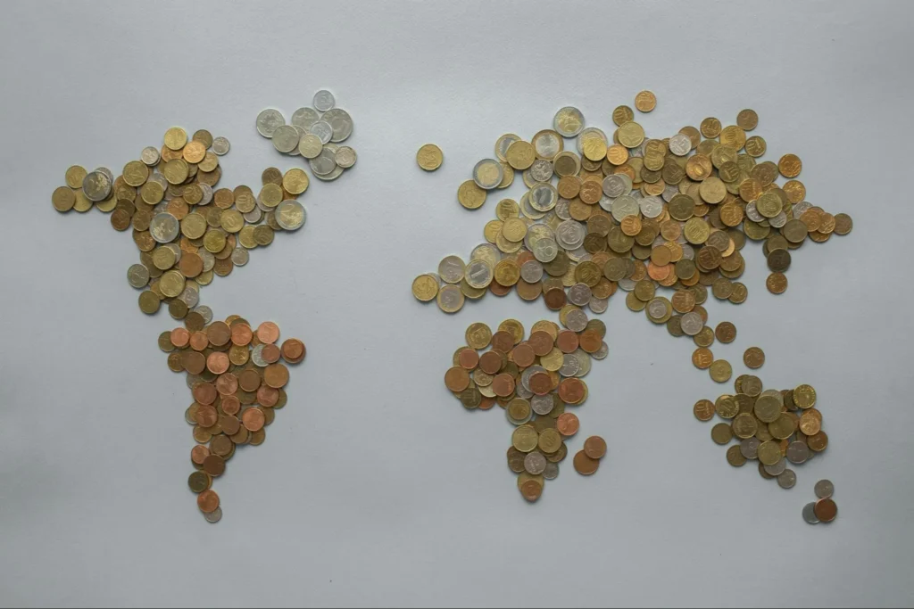 Coins creating a world map, highlighting the global market that PayFacs cater to.