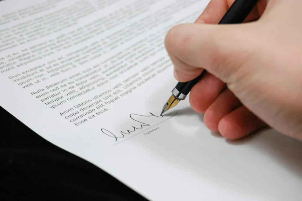 A business owner signing a payment processing contract.