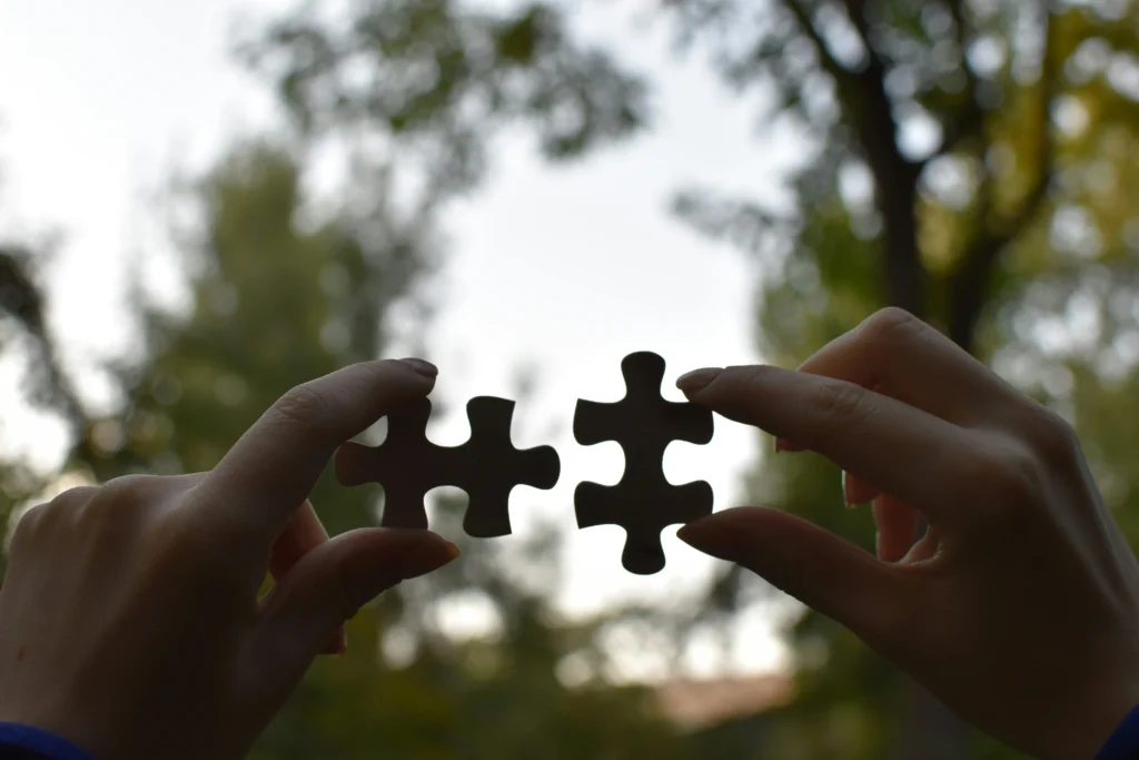 Two pieces of a jigsaw puzzle coming together, like a business and merchant account provider.
