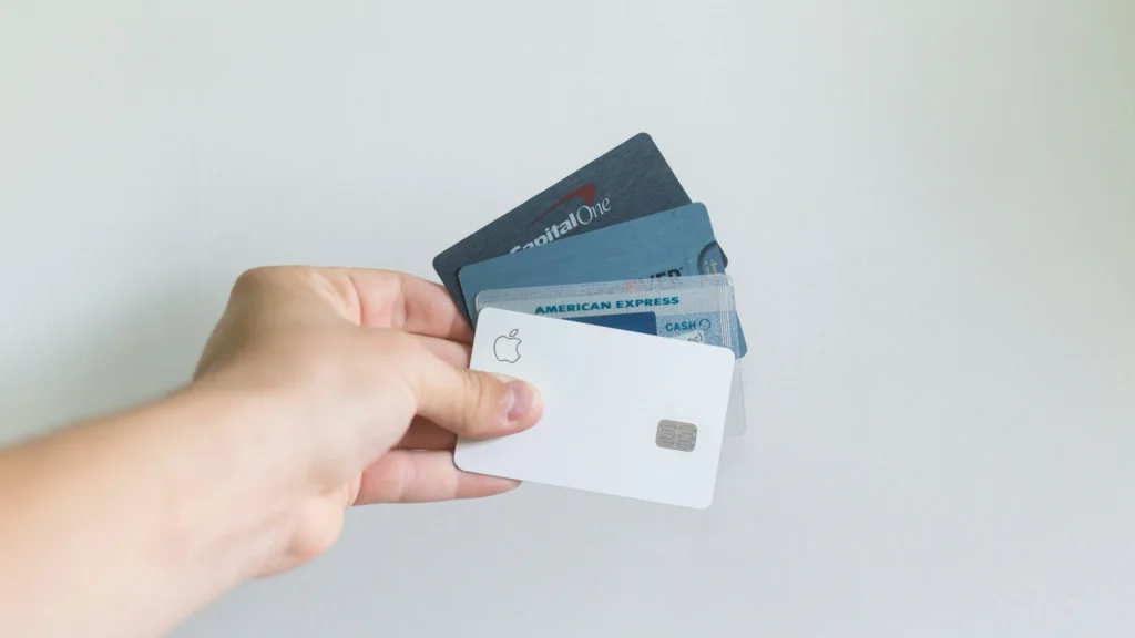 A customer holding several credit cards, allowing them to optimize their cash flow when temporary holds are in effect.