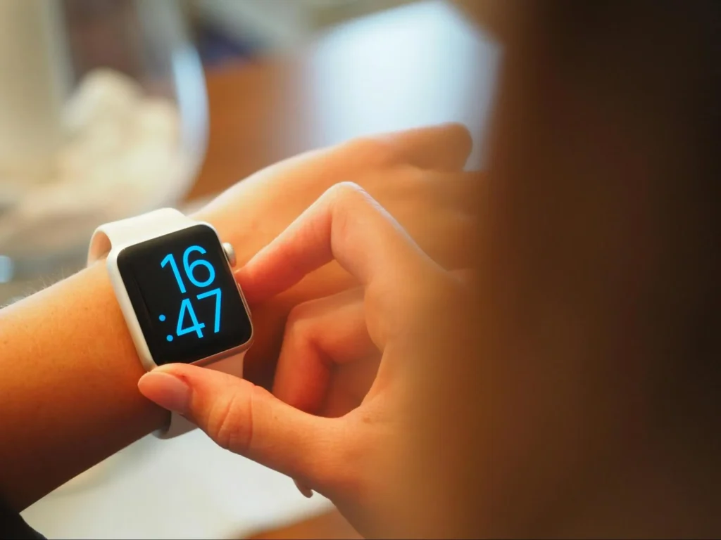 A business owner checking the time as part of their settlement timing strategy.