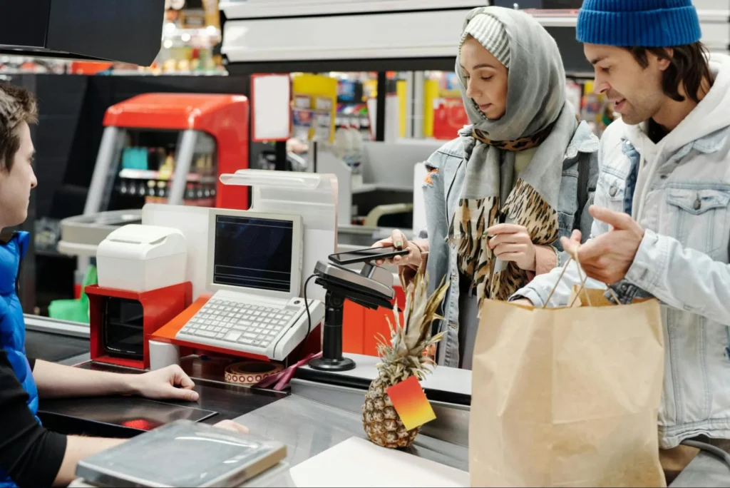 A couple purchasing their groceries with a mobile payment app.