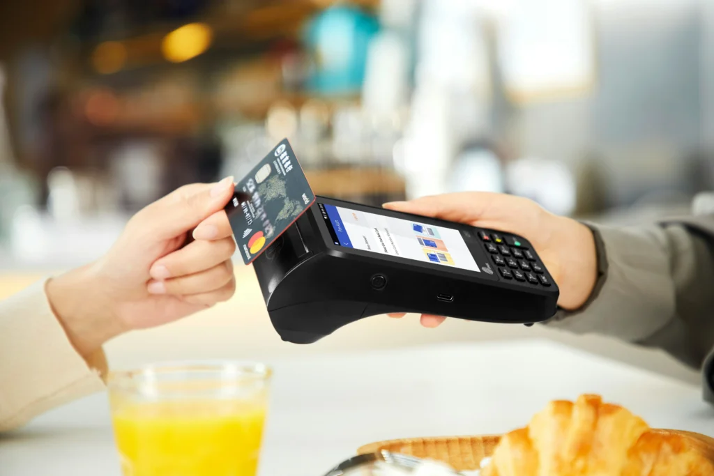 A customer making a payment in a franchise coffee shop.
