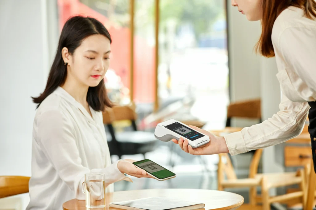 A customer making an electronic payment for goods in a store.