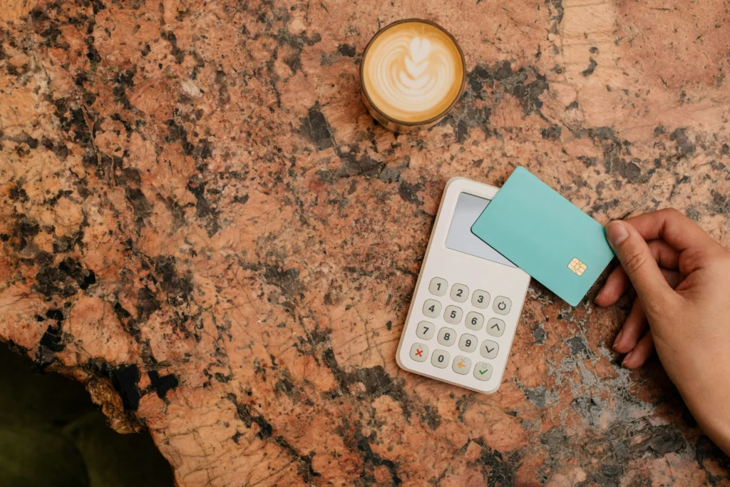 A customer making a payment by card, which then enters the payment processing system.