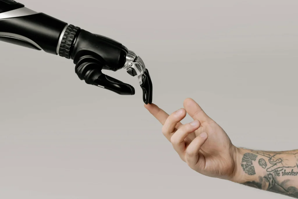A robot hand and a human hand, representing how AI can help with optimizing the payment process.