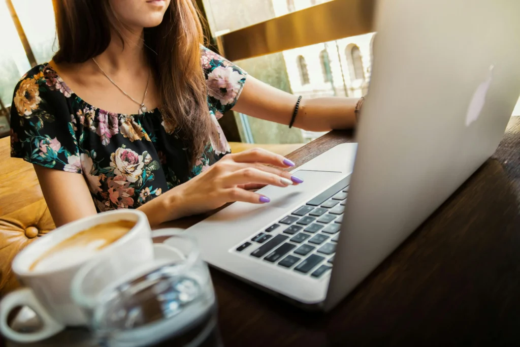 A freelancer working at a laptop, while also exploring payment options.