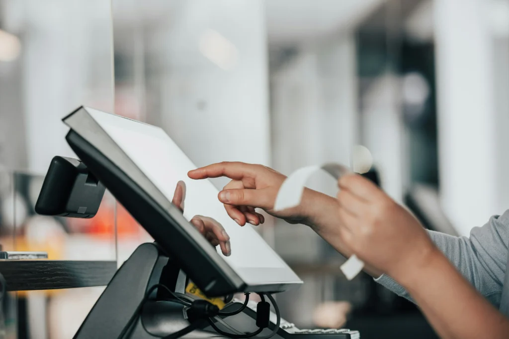 An employee using a point of sale system.