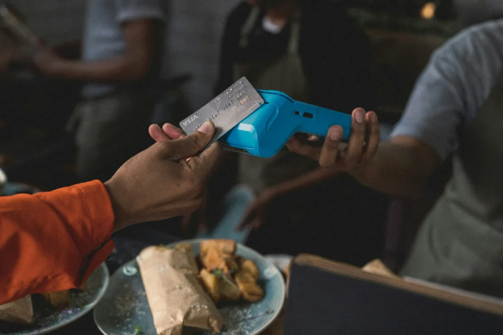 A customer making a payment by card, kickstarting the payment processing journey.